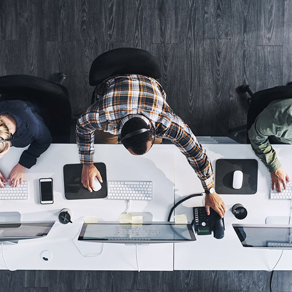people working on computers at desk
