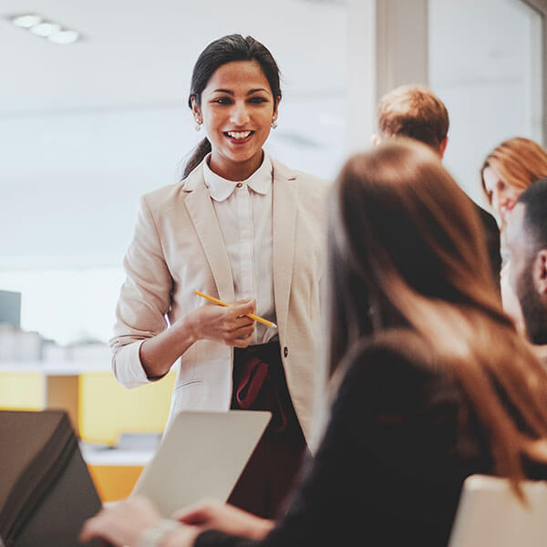 woman talking to co-workers in meeting